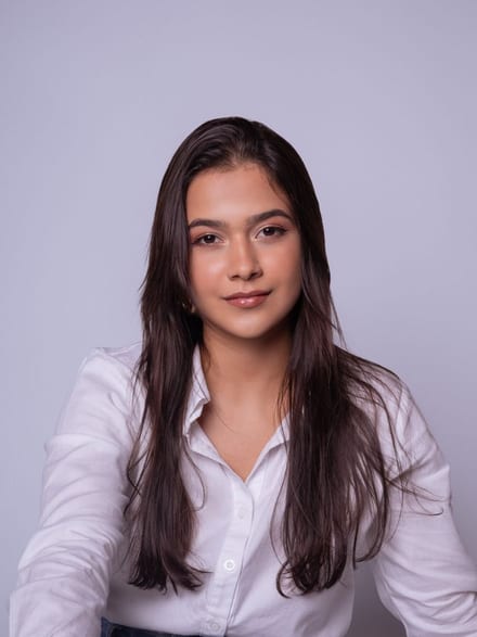 A casual portrait taken against a plain coloured wall, before processing